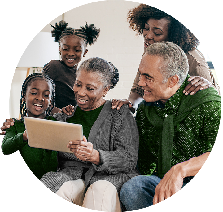 A smiling family looking at a tablet